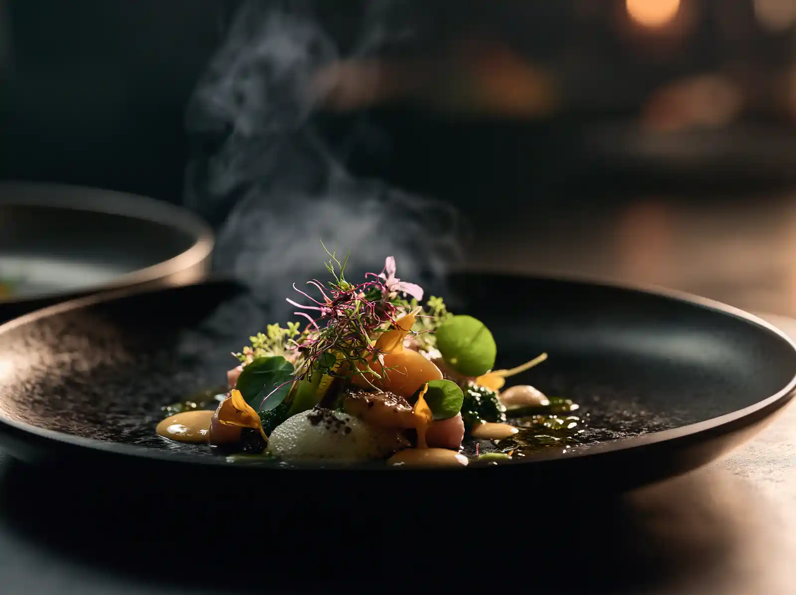 A tasting-menu course plated in a dark bowl