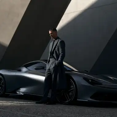 A figure beside a concept supercar